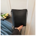 Chic black litchi texture bucket bag featuring a silver metal chain and leather strap - Black