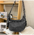 Macro detail of washed denim hobo bag featuring vintage snowflake texture and black zipper - Vintage Black