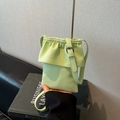 Light green pebble leather mini crossbody bag with drawstring flap and shoulder strap - Green