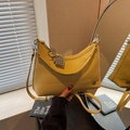 Vibrant yellow half-moon crossbody bag in lychee pattern faux leather with bead charm - With Charm / Yellow