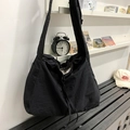 Large black drawstring crossbody bag with pleated nylon texture and wide shoulder strap - Black