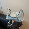 Minimalist light blue pebble leather shoulder bag with metallic grape pendant and strap - With Charm / Blue