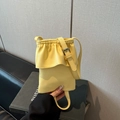 Lemon yellow pleated bucket crossbody bag in lychee pattern faux leather with adjustable strap - Yellow