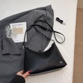 Elegant black lychee texture dumpling bag with adjustable strap on white bedding - No Pendant / Black