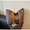 Detailed view of dark grey canvas tote bag with orange embroidery and leather straps - Dark Brown