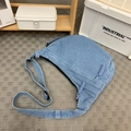 Light blue denim crescent crossbody bag with purple woven zipper detail and strap - Light Blue