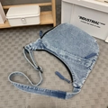 Light blue denim half-moon crossbody bag with adjustable strap and black zipper details - Vintage Blue