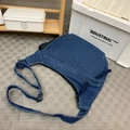 Large blue denim dumpling bag with contrast stitching and adjustable crossbody strap - Dark Blue