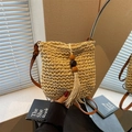 Handmade beige straw bucket bag with bohemian tassel fringe and wood bead accents - Off White