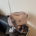 Minimalist grey-brown nylon crossbody pillow bag with adjustable wide strap and JP logo - Gray