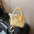 Yellow litchi leather bucket bag with pearl charm and white ribbon handles - With Charm / Yellow