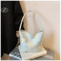 Light blue canvas hobo bag with yellow floral print in a minimalist travel setup - Green