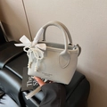 Light gray lychee leather bucket bag with ribbon bow and pearl charm strap - With Charm / Gray