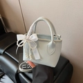 Light blue lychee leather bucket bag with silk ribbon handle and pearl charm detail - With Charm / Blue