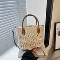 Beige woven straw bucket bag featuring brown leather handles and adjustable shoulder strap - Off White