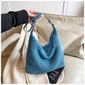 Detail of blue crochet hobo bag showing woven texture and leather strap with metal buckle - Blue