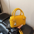 Mini yellow Boston bag in pebble leather with top handles and silver ball pendant - Ginger Yellow (With Charm)