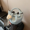 Light blue lychee leather bucket bag with top handle and plush puppy pendant - With Charm / Blue