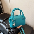Mini Boston bag in teal blue pebble leather with round handles and silver pendant - Blue (With Charm)