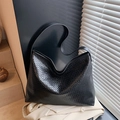 Black large woven tote bag with a minimalist shoulder strap in a matte leather finish - Black