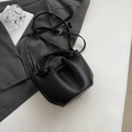Chic black litchi textured bucket bag with unique knotted handle and shoulder strap - No Pendant / Black