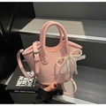 Pink lychee texture bucket bag with pearl bow and lace charm on black art book - With Pearl Lace Bow Charm / Pink