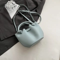 Light blue lychee textured leather bucket bag with knot handle and adjustable strap - No Pendant / Blue