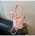 Pink lychee grain leather bucket bag with checkered scarf handle and slim strap detail - Pink