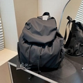 Minimalist black nylon drawstring backpack for women featuring a spacious main compartment - Black