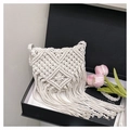 Detail of handmade bohemian woven cotton crossbody bag with long tassels in a gift box - Off-white