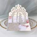 Macro detail of laser-cut wedding invitation with silver glitter and pink floral inner - Silver Glitter