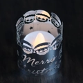 Close-up of LED Christmas candle with Merry Christmas metal cover and Santa cutout - Mirror Silver