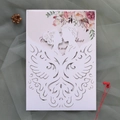 Detailed laser-cut wedding invitation featuring a kissing couple and floral insert card - White