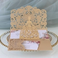 Detail of laser-cut gold wedding invitation with elegant girl silhouette and floral inner card - Beige Gold