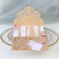 Macro detail of laser-cut pop-up wedding invitation with champagne lace floral pattern - Champagne Gold