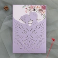 Detail of purple laser cut wedding invitation with floral insert on green tulle - Lilac Purple