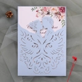 Detail of laser-cut light blue wedding invitation with floral inner card on grey mesh - Fog Blue