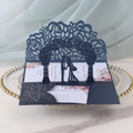 Macro view of blue laser-cut 3D wedding invitation with rose hollow patterns - Magic Blue