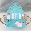 Detail view of light blue laser cut wedding invitation with 3D bride and groom silhouette - Teal Blue