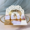 Detail of laser-cut 3D wedding invitation with gold silhouette and floral interior - Reflective Gold