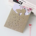 Detail of laser-cut glitter wedding invitation featuring a bride and groom silhouette - Cyan Gold