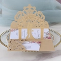 Detail of laser-cut 3D gold wedding invitation with floral arch and couple silhouette - Beige Gold