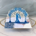 Macro shot of 3D laser-cut blue glitter wedding card with rose arch and couple silhouette - Glitter Royal Blue
