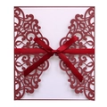 Close-up of deep red laser-cut floral invitation cover with ribbon bow and white insert - Dark Red