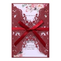 Close-up of laser cut wine red wedding invitation with elegant red ribbon bow detail - Dark Red