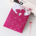 Close-up of laser-cut rose pink glitter paper wedding card with floral silhouette detail - Rose Red
