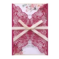 Macro detail of laser-cut butterfly invitation with pink glitter and white ribbon bow - Glitter Rose Red