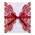 Detail of red laser cut wedding invitation with intricate lace pattern and satin ribbon - Glitter Red