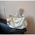 Close-up of mint blue cloud texture tote bag with silver chain and cute plush bear charm - Blue