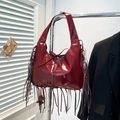 Burgundy patent leather tote bag with long fringe accents and shoulder strap - Red